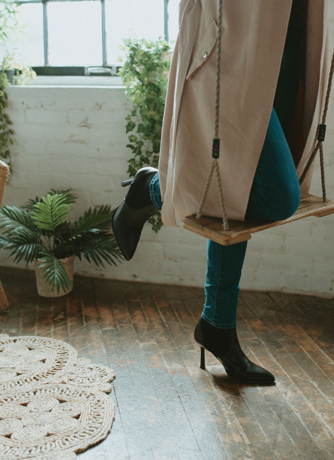 Studio scene with boots on a wooden swing